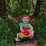 baby, child, watermelon, red_bow, green_foliage, outdoor, crate, grass, trees, smiling, sitting, nature, summer, fruit, cute, happy, baby_clothes, barefoot, wood, playful
