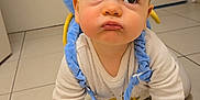 Ezio participe au concours pour gagner de l'argent avec cette photo : baby, backpack, blue, child, clothing, crawling, curious, cute, expression, floor, foot, hand, indoors, infant, person, plush, pout, tile, wide_eyes, yellow