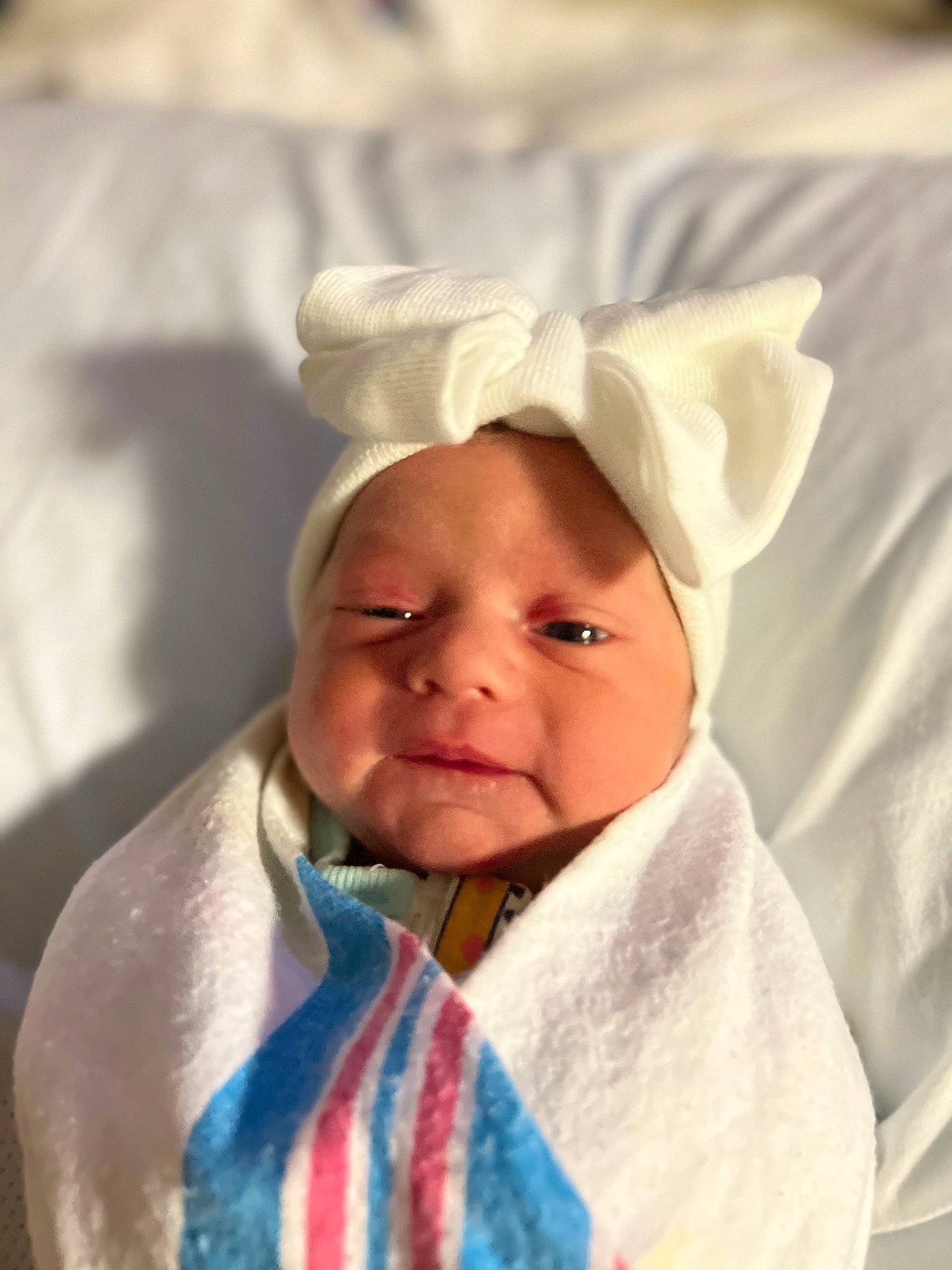 Kallie is registered to the contest to win money with this photo: baby, baby_toddler_clothing, cheek, child, collar, comfort, face, happy, hat, headwear, linens, person, portrait_photography, room, sleeve, toddler