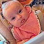 baby, bib, high_chair, towel, face, child, indoor, curious, pink, clothing, feeding, person, infant, cute, head, seat, expression, skin, baby_food, table