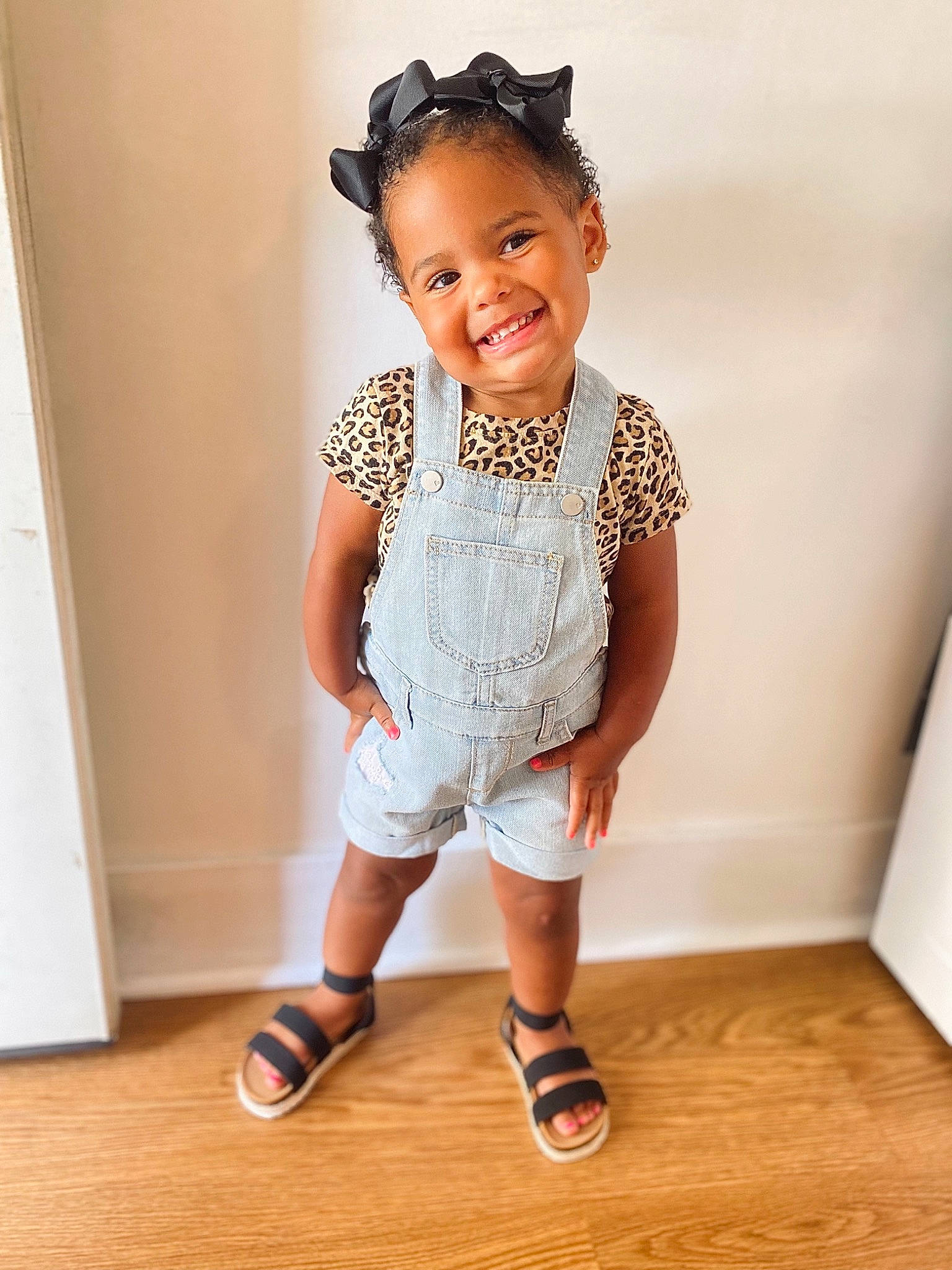 Londyn joined the competition — help win amazing prizes! baby_toddler_clothing, child, face, floor, flooring, foot, hair, happy, hardwood, human_leg, joy, knee, pattern, person, sleeve, smile, sock, t_shirt, thigh, toddler