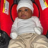 Amir joined the competition — help win amazing prizes! baby, infant, car_seat, red, white_clothing, hat, mittens, pants, shoes, child, cute, indoor, portrait, seated, young, face, expression, cozy, comfortable, carrier
