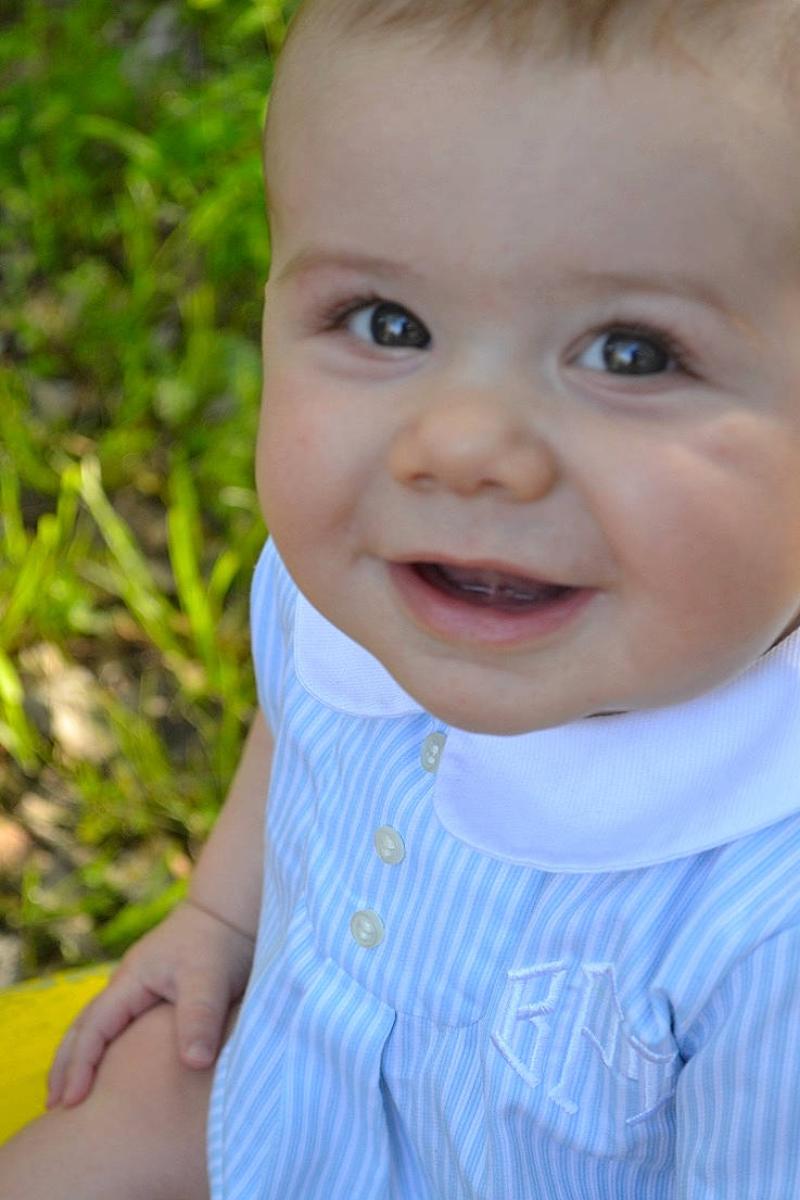 Brixton is registered to the contest to win money with this photo: baby, blue, cheek, child, chin, close_up, eye, face, facial_expression, forehead, grass, happy, head, iris, joy, lip, nose, people, person, skin