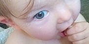 Dakota joined the competition — help win amazing prizes! baby, child, toddler, skin, hand, face, blue_eyes, hair, mouth, thumb, diaper, sitting, curious, closeup, indoors, soft_surface, innocent, cute, expression, person