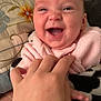 Valerie joined the competition — help win amazing prizes! baby, smiling, hand, blanket, pink_clothing, face, infant, happy, person, playing, cozy, indoor, pillow, human, cute, tickling, closeup, expression, child, soft