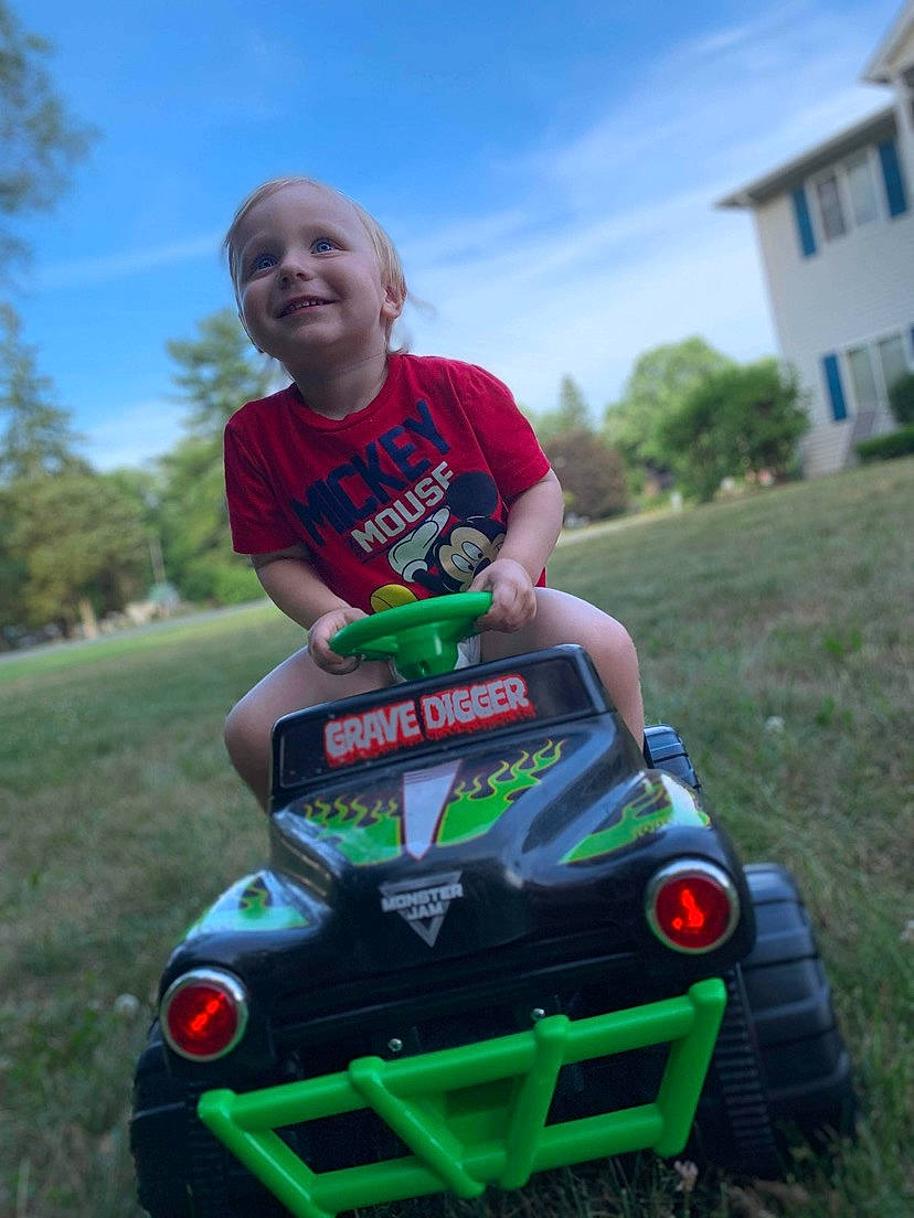 Averie joined the competition — help win amazing prizes! automotive_design, automotive_exterior, automotive_lighting, automotive_tire, bumper, car, grass, head, jeans, joy, motor_vehicle, person, plant, shorts, sky, smile, tire, toy, tree, vehicle