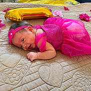 Maryory joined the competition — help win amazing prizes! baby, newborn, child, infant, portrait, pink_dress, headband, flower, balloon, gold_balloon, quilt, bed, lying_down, smiling, face, eyes, hands, indoor, celebration, colorful
