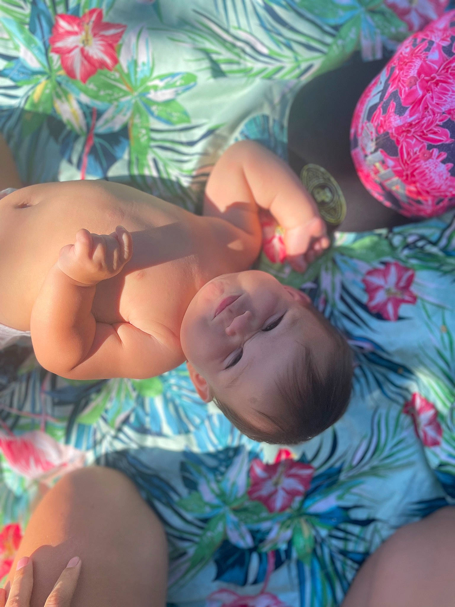 Leoki is registered to the contest to win money with this photo: abdomen, baby, chest, comfort, facial_expression, finger, grass, happy, head, human_body, leg, mouth, muscle, orange, person, pink, skin, textile, thigh, thumb
