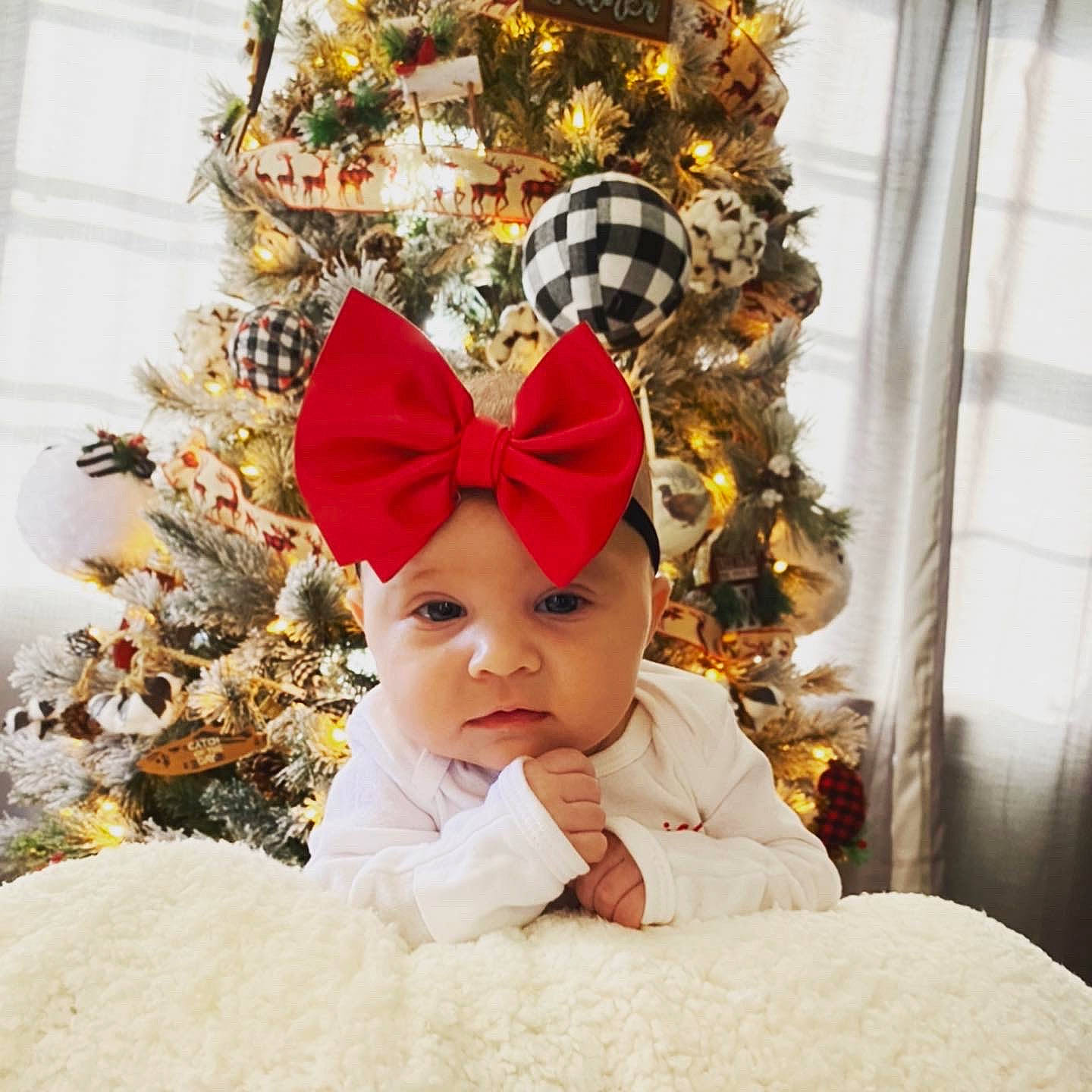 Laney is registered to the contest to win money with this photo: baby, baby_toddler_clothing, christmas, christmas_decoration, christmas_eve, christmas_ornament, christmas_tree, conifer, costume, costume_accessory, costume_hat, curtain, hair_accessory, headgear, headwear, holiday, holiday_ornament, interior_design, ornament, person