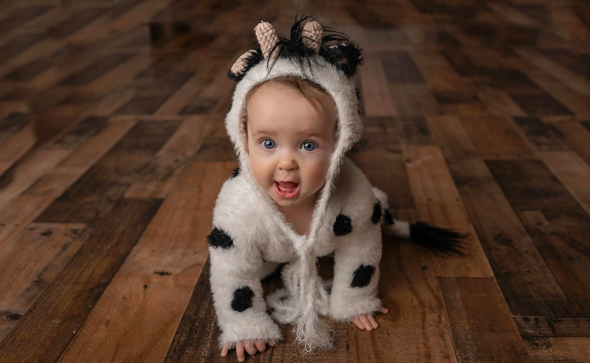 Amelia is registered to the contest to win money with this photo: baby, baby_toddler_clothing, black_hair, child, embellishment, fashion_accessory, fawn, flash_photography, flooring, fun, fur, happy, hardwood, headband, headpiece, iris, person, smile, surprise, toddler