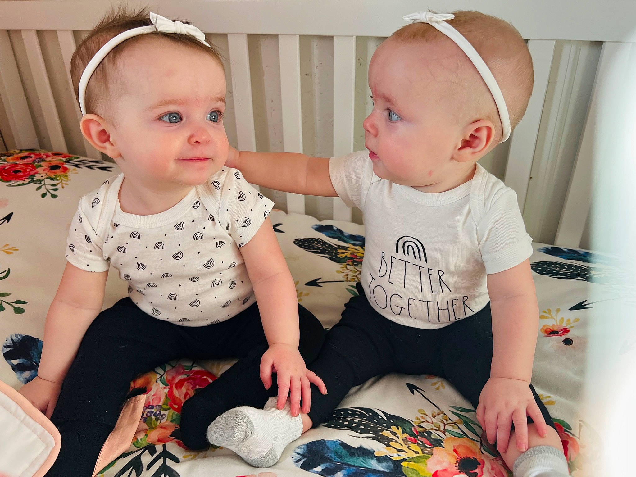 Amelia is registered to the contest to win money with this photo: arm, baby, baby_products, baby_toddler_clothing, cap, cheek, child, facial_expression, fashion_accessory, fun, happy, pattern, person, product, room, shorts, sitting, skin, sleeve, t_shirt