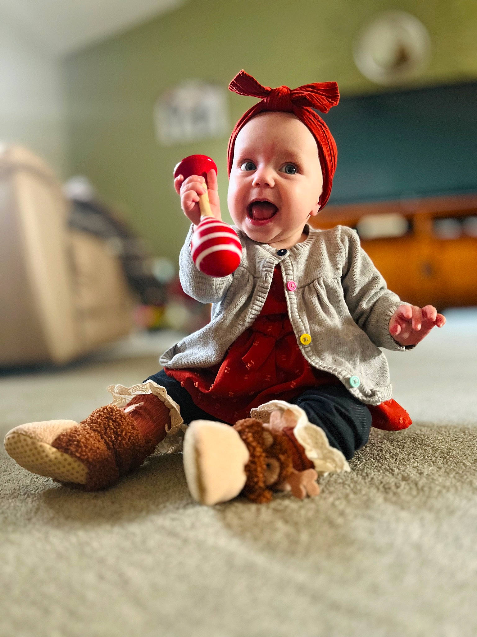 Sofia is registered to the contest to win money with this photo: baby, baby_toddler_clothing, carmine, child, costume_hat, event, fictional_character, flooring, foot, fun, fur, happy, hat, human_leg, mammal, person, sitting, sleeve, smile, toddler