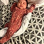 Iris is registered to the contest to win money with this photo: baby, sleeping, onesie, floral_pattern, blanket, geometric_pattern, bed, pillow, child, peaceful, rest, infant, soft, cozy, indoor, cute, person, comfort, relaxing, home