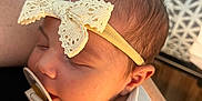 Iris joined the competition — help win amazing prizes! baby, sleeping, pacifier, headband, lace, bow, infant, person, closeup, soft_lighting, blanket, arm, skin, newborn, resting, cozy, cute, child, indoor, portrait