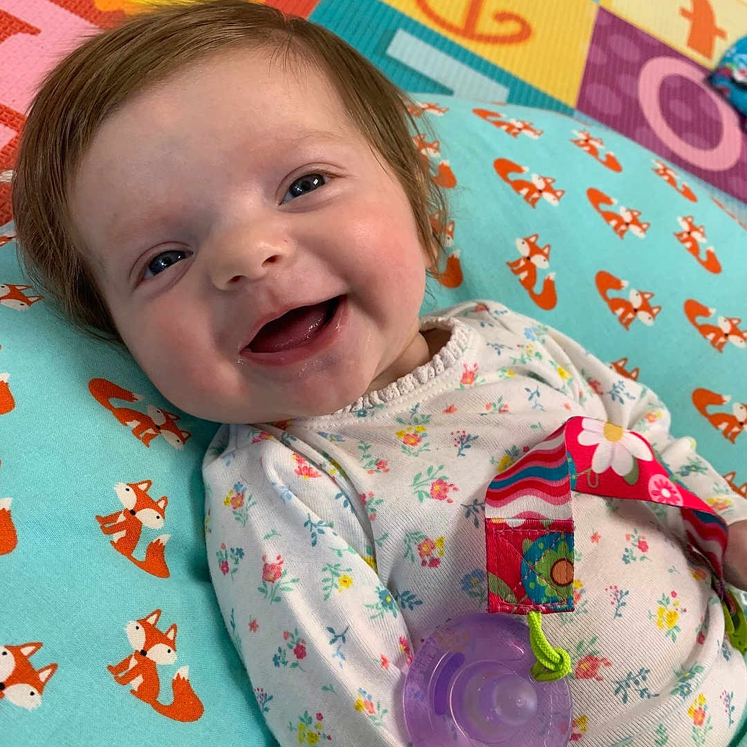 Maria joined the competition — help win amazing prizes! baby, bedding, cheek, child, face, happy, linens, lip, nap_mat, pattern, person, pink, play, skin, smile, textile, toddler