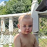 baby, backyard, balustrade, blond_hair, blue_eyes, child, daylight, diaper, fence, outdoor, porch, portrait, railing, serious_expression, shirtless, sky, standing, sunny, toddler, trees