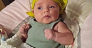 Rhiannon joined the competition — help win amazing prizes! baby, infant, child, portrait, wide_eyed, indoor, blanket, bassinet, headscarf, yellow, green_outfit, white_blanket, lying_down, sitting, face, eyes, arms, wood_paneling, cozy, nursery