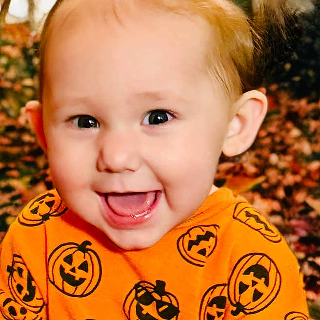 Marceline is registered to the contest to win money with this photo: autumn, child, cute, face, fall, festive, happy, joyful, leaves, nature, orange_shirt, outdoor, person, pigtails, portrait, pumpkin_pattern, seasonal, smiling, toddler, young_child