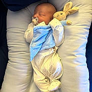 Teddy joined the competition — help win amazing prizes! newborn, baby, sleeping, pacifier, plush_toy, bunny, blanket, onesie, pillow, cushion, infant, cute, cozy, resting, soft, child, indoor, comfort, adorable, peaceful