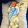 newborn, baby, sleeping, pacifier, plush_toy, bunny, blanket, onesie, pillow, cushion, infant, cute, cozy, resting, soft, child, indoor, comfort, adorable, peaceful