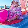 Inaya participe au concours pour gagner de l'argent avec cette photo : baby, beach, beach_mat, blue_sky, bucket, child, outdoor, pacifier, person, pink_towel, relaxation, sand, sea, summer, sunhat, sunny, sunshade, toddler, vacation, water