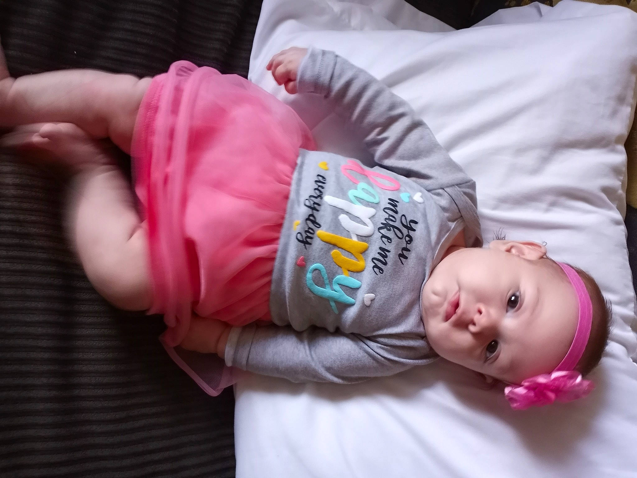 Octavia is registered to the contest to win money with this photo: baby, baby_products, baby_toddler_clothing, cheek, child, comfort, facial_expression, linens, mammal, person, pillow, room, sitting, skin, sleeve, textile, thumb, toddler, vertebrate, wood