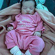 Diana participe au concours pour gagner de l'argent avec cette photo : baby, sleeping, pink_clothing, blanket, socks, infant, cozy, cute, soft, child, resting, indoors, portrait, newborn, warm, comfort, peaceful, hands, feet, head