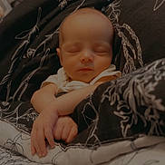 Saige is registered to the contest to win money with this photo: baby, sleeping, blanket, infant, cozy, peaceful, child, wrapped, soft, bed, resting, cute, newborn, person, portrait, hands, face, indoor, calm, comfort