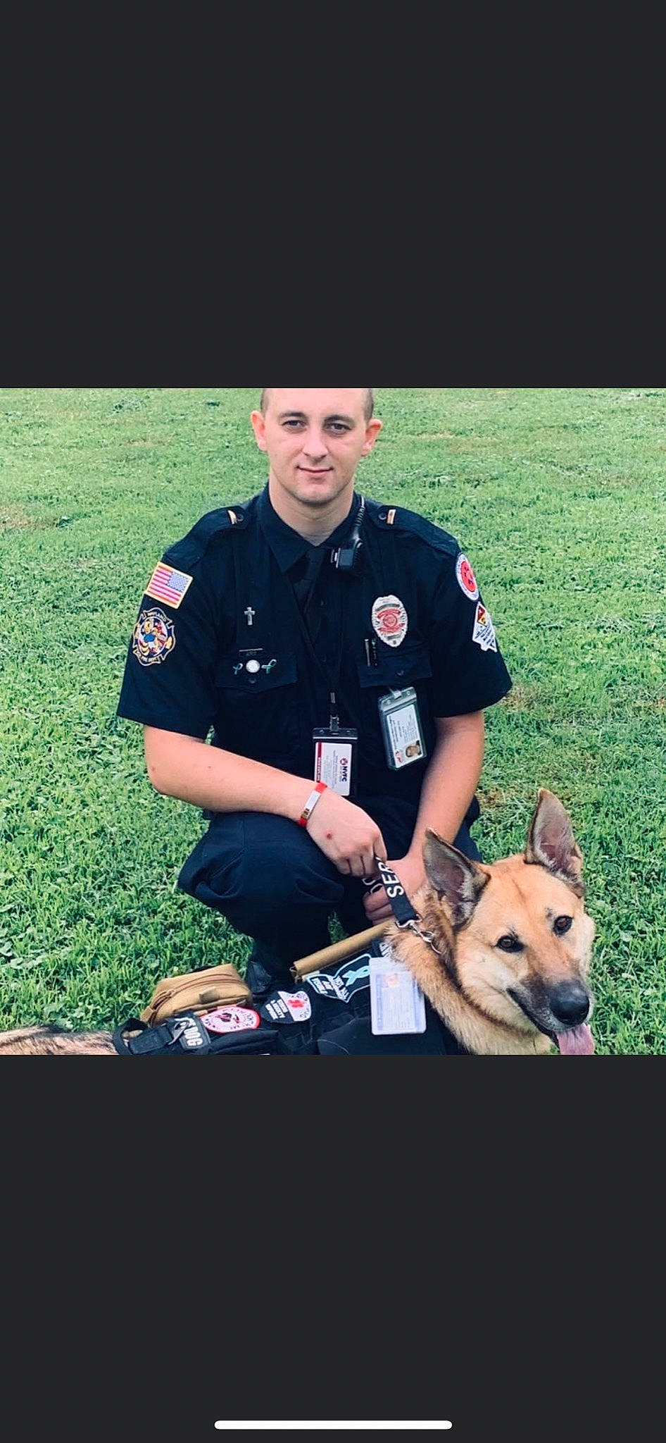 Lucy is registered to the contest to win money with this photo: canidae, carnivore, companion_dog, dog, dog_breed, event, gesture, grass, herding_dog, law_enforcement, military_officer, military_person, military_uniform, non_commissioned_officer, official, park_ranger, recreation, security, sporting_group, uniform