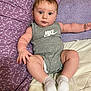 baby, infant, child, onesie, nike, gray_clothing, white_socks, bed, blanket, purple_blanket, cream_blanket, chubby_arms, chubby_legs, blue_eyes, curious_expression, indoor, portrait, person, cute, relaxed