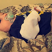 Michael is registered to the contest to win money with this photo: arm, baby, bed, bedtime, birth, cheek, child, cloud, cool, furniture, human, leg, nap, room, skin, sleep, tattoo, toddler, trunk