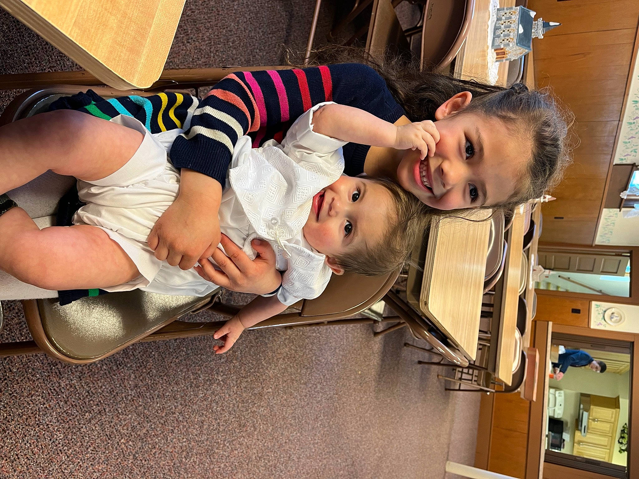 Tucker is registered to the contest to win money with this photo: baby, baby_products, baby_toddler_clothing, child, comfort, dress, foot, fun, happy, human_leg, joy, knee, lap, person, room, sandal, sitting, smile, sock, thigh