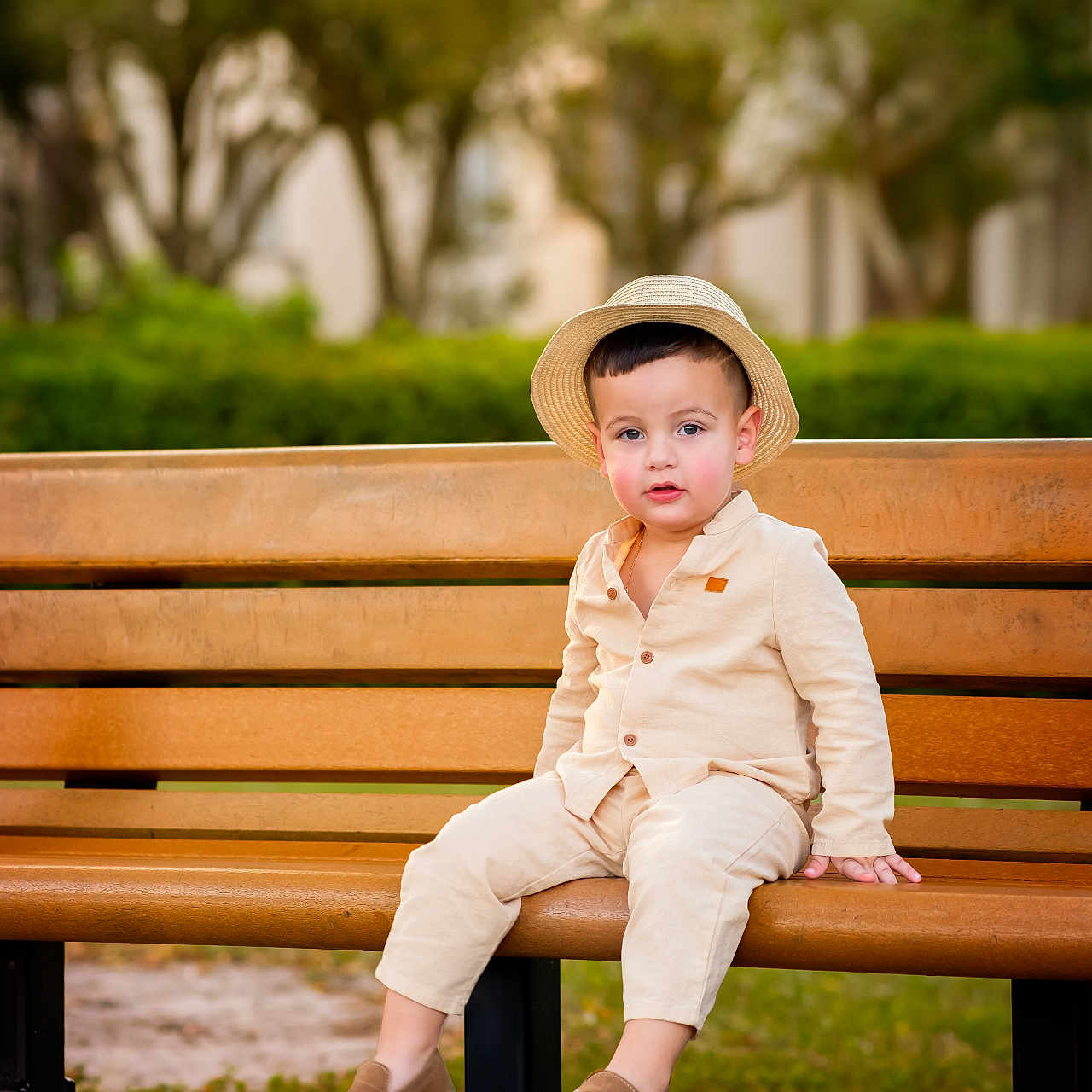 Dylan Michel joined the competition — help win amazing prizes! background_blur, bench, casual_clothing, child, curious, cute, daylight, face, greenery, hat, nature, outdoor, park, person, portrait, shoes, sitting, toddler, wood, young_child