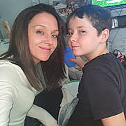 Kaiden joined the competition — help win amazing prizes! woman, boy, child, indoor, selfie, smile, cup, television, cartoon, furniture, casual_clothing, hair, face, living_room, person, home, relaxed, portrait, young, fun