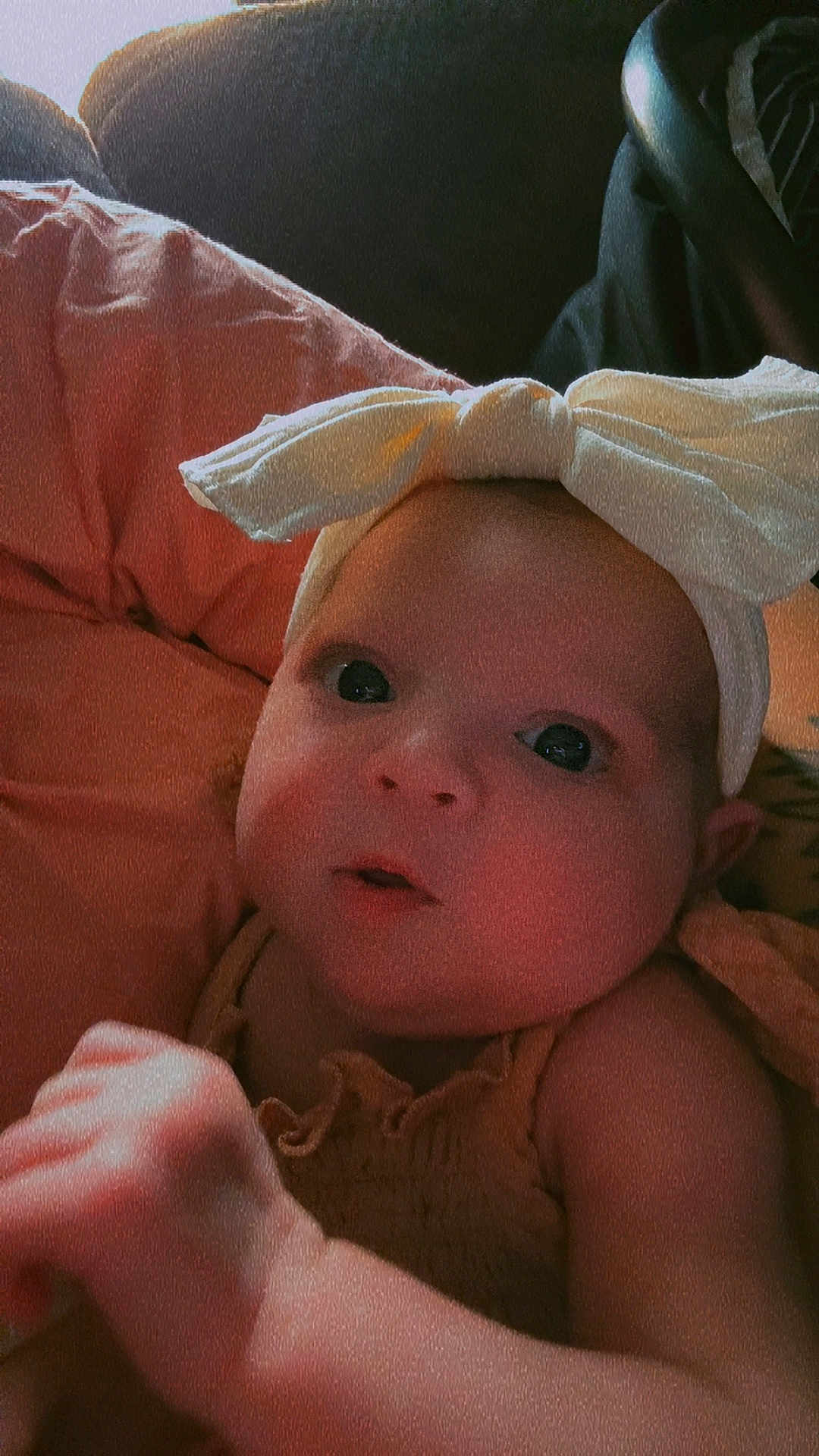 Aurora joined the competition — help win amazing prizes! baby, child, face, headband, bow, looking, curious, closeup, portrait, infant, skin, hand, soft, warm_lighting, expression, clothing, indoors, young, cute, person