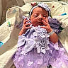 newborn, baby, infant, portrait, hospital, hospital_bed, blanket, lavender_dress, headband, bow, floral_dress, baby_girl, face, hands, smiling, awake, birth_card, bedding, indoor, photography