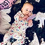 Lakota is registered to the contest to win money with this photo: baby, bedding, blanket, clothes, cute, fabric, gaze, hanger, holding, infant, lying_down, nursery, onesie, patterned_clothing, pillow, portrait, soft_toy, tag, teether, wide_eyes