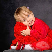 Katalyna participe au concours pour gagner de l'argent avec cette photo : toddler, child, red_clothing, smile, hugging, plush, portrait, studio, cute, happy, girl, dress, sitting, soft_texture, indoor, blond_hair, blue_eyes, cozy, fashion, innocence