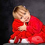 toddler, child, red_clothing, smile, hugging, plush, portrait, studio, cute, happy, girl, dress, sitting, soft_texture, indoor, blond_hair, blue_eyes, cozy, fashion, innocence