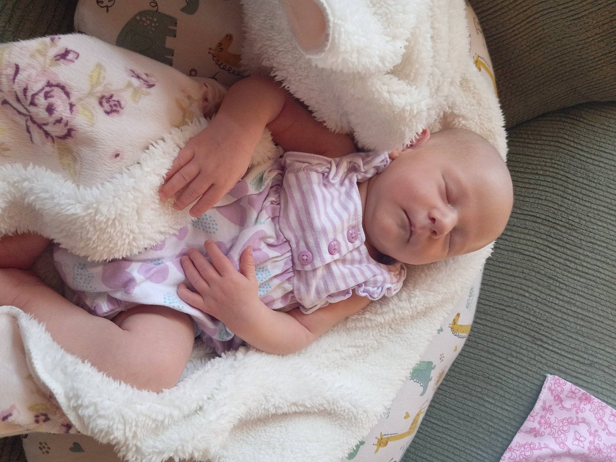 Tina is registered to the contest to win money with this photo: baby, baby_products, baby_sleeping, baby_toddler_clothing, cheek, comfort, couch, eyelash, finger, head, human_body, iris, leg, linens, nail, pattern, person, sitting, skin, sleeve