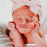 newborn, baby, infant, headband, pink_bow, sleeping, hands, face, skin, cute, portrait, resting, white_blanket, peaceful, child, closeup, adorable, soft_light, infancy, young_child