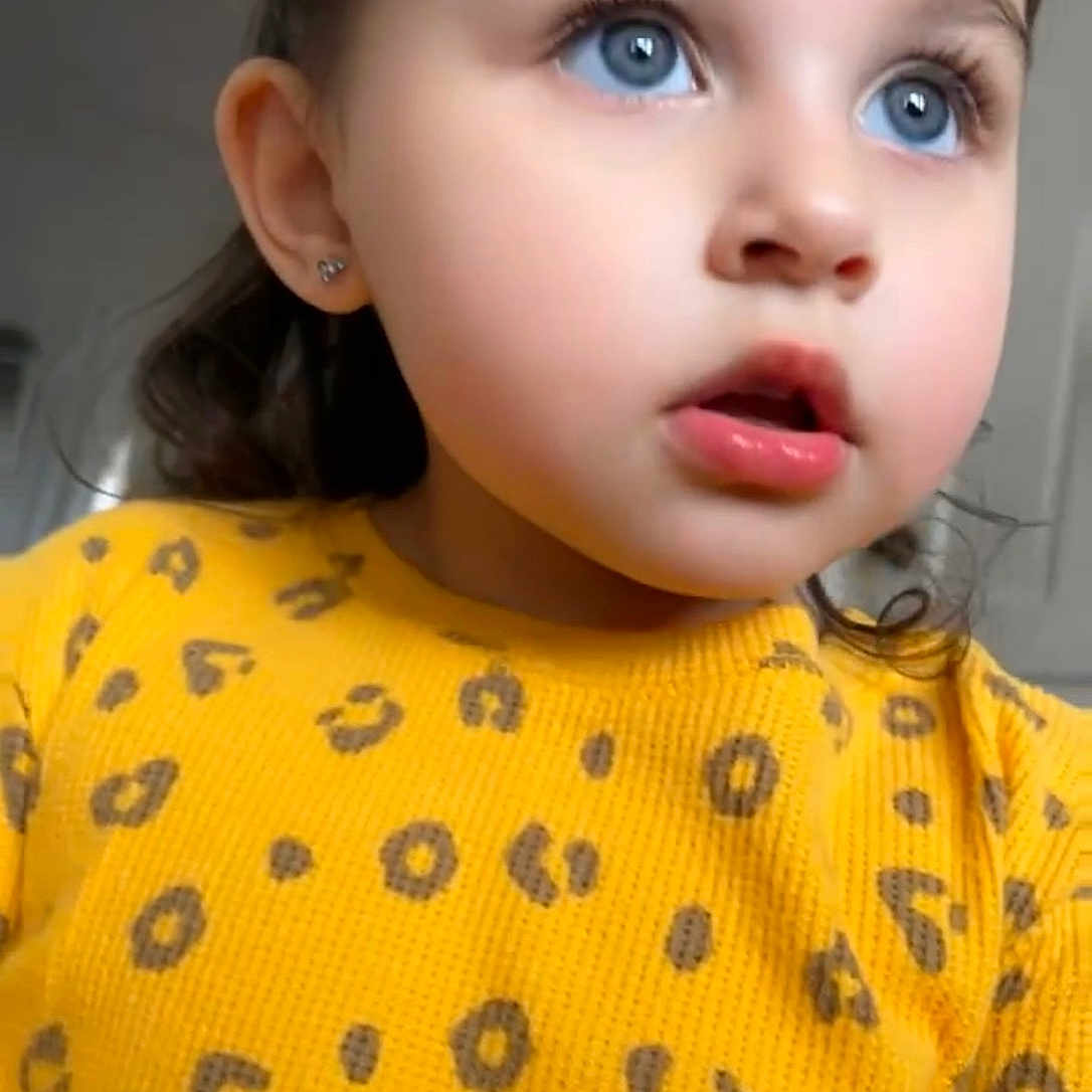 Ava joined the competition — help win amazing prizes! blue_eyes, child, clothing, curly_hair, cute, earrings, expression, face, fashion, hair, indoor, leopard_print, looking_away, person, portrait, skin, sweater, toddler, yellow_sweater, young_child