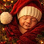 Joseph joined the competition — help win amazing prizes! baby, sleeping, red_hat, knit_hat, blanket, christmas_lights, holiday, festive, greenery, red_berries, warm_lighting, cozy, portrait, newborn, smiling, face, closeup, christmas_decor, soft_texture, holiday_season