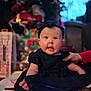 Marnie joined the competition — help win amazing prizes! baby, infant, child, black_dress, headband, hand, face, blue_eyes, expression, indoor, holiday, decorations, blurred_background, candid, cute, person, sitting, soft_lighting, festive, supporting_hand