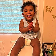 Karmelo joined the competition — help win amazing prizes! toddler, child, smiling, clapping, curly_hair, diaper, sleeveless_shirt, white_table, indoor, window, blind, butterfly_decals, wall, hand_soap, personal_items, happy, cute, feet, seat, home