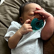 Elijah joined the competition — help win amazing prizes! baby, bed, bedding, blanket, closeup, cozy, face, family_photo, gray_clothing, hair, hands, indoors, infant, newborn, onesie, pacifier, pillow, portrait, resting, sleeping