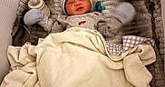 Elijah is registered to the contest to win money with this photo: baby, baby_bottle, bassinet, blanket, caregiver_gear, cozy, cream, crying, gray, hat, indoor, infant, mittens, newborn, nursery, pacifier, portrait, sleeping, swaddle, textile