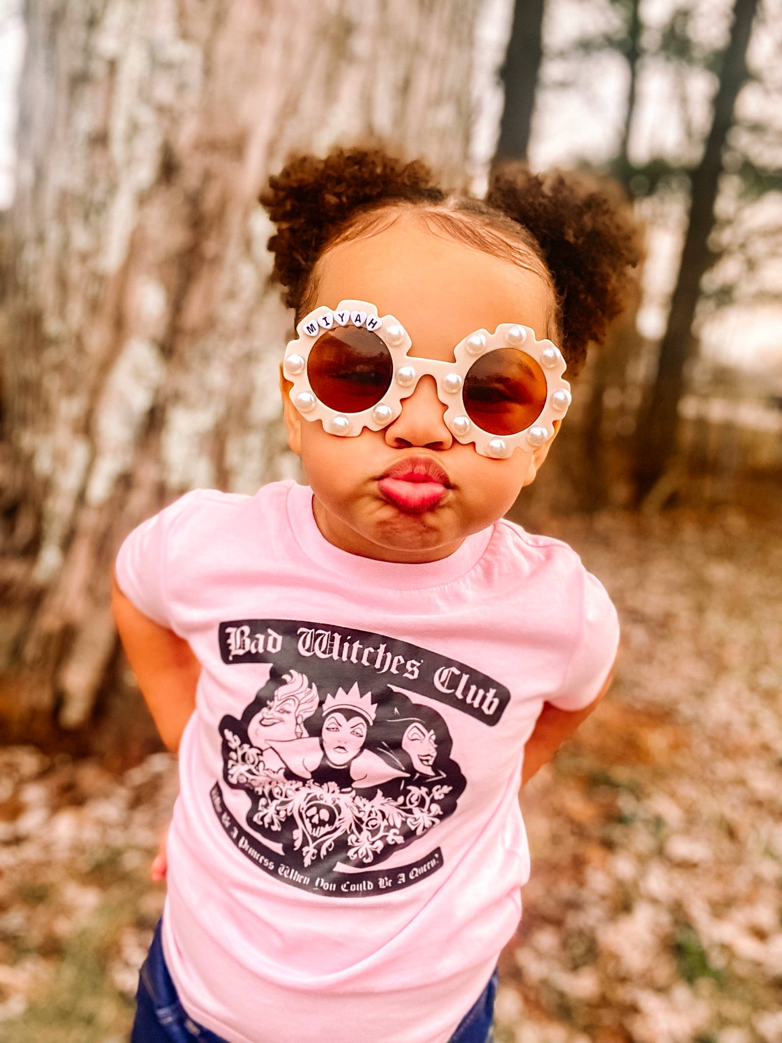 Amiyah is registered to the contest to win money with this photo: brown_hair, clothing, eyewear, fun, glasses, goggles, grass, happy, leisure, lip, magenta, neck, person, personal_protective_equipment, sleeve, street_fashion, sunglasses, t_shirt, toddler, tree