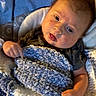 baby, blanket, blue, child, clothing, cute, face, fingers, hand, knitted_blanket, laying_down, looking, person, portrait, skin, soft_texture, toddler, warm, young_child, expression