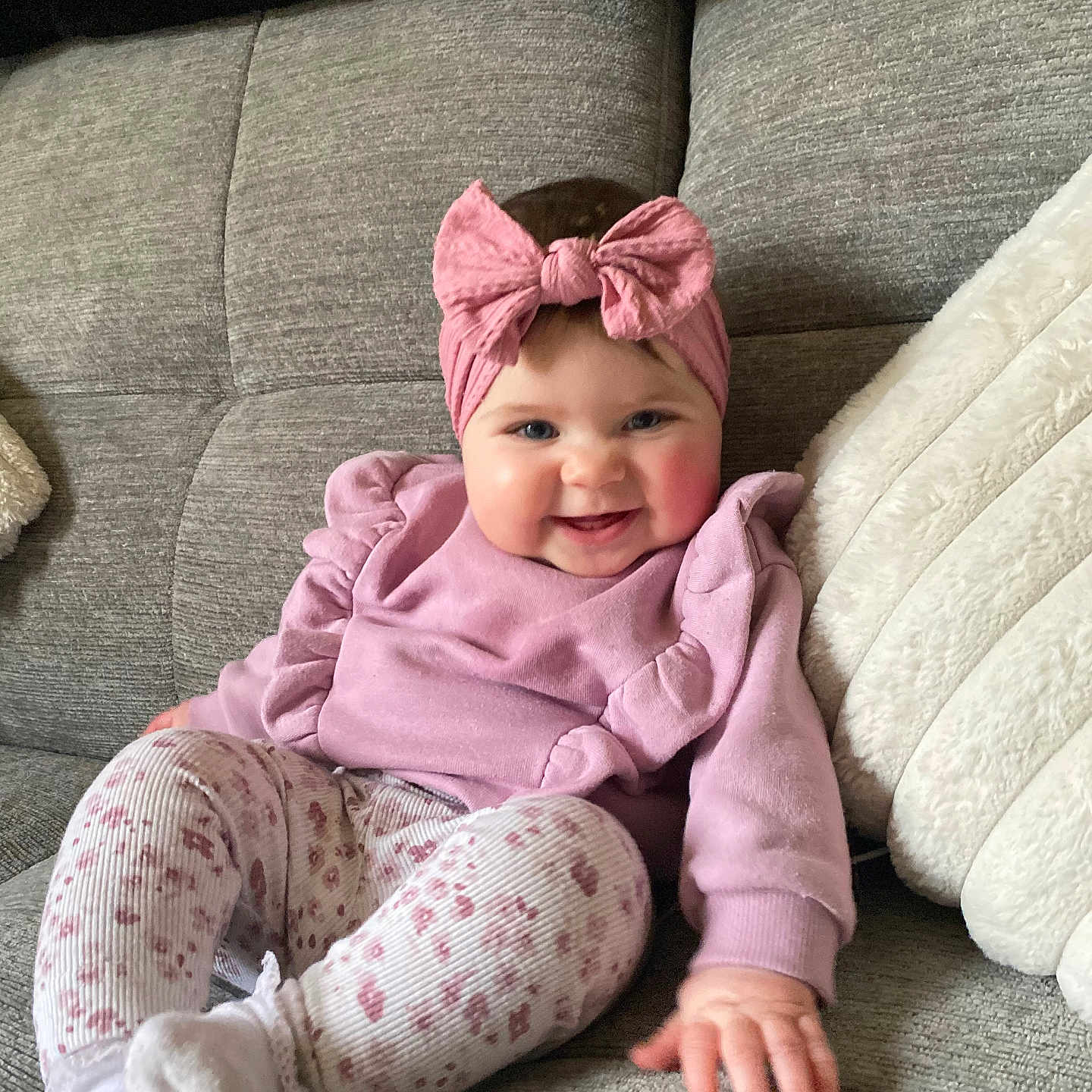 Ava-May joined the competition — help win amazing prizes! baby, bonnet, cap, clothing, couch, cushion, face, furniture, happy, hat, head, homedecor, hood, pajamas, pants, person, photography, portrait, sitting, smile